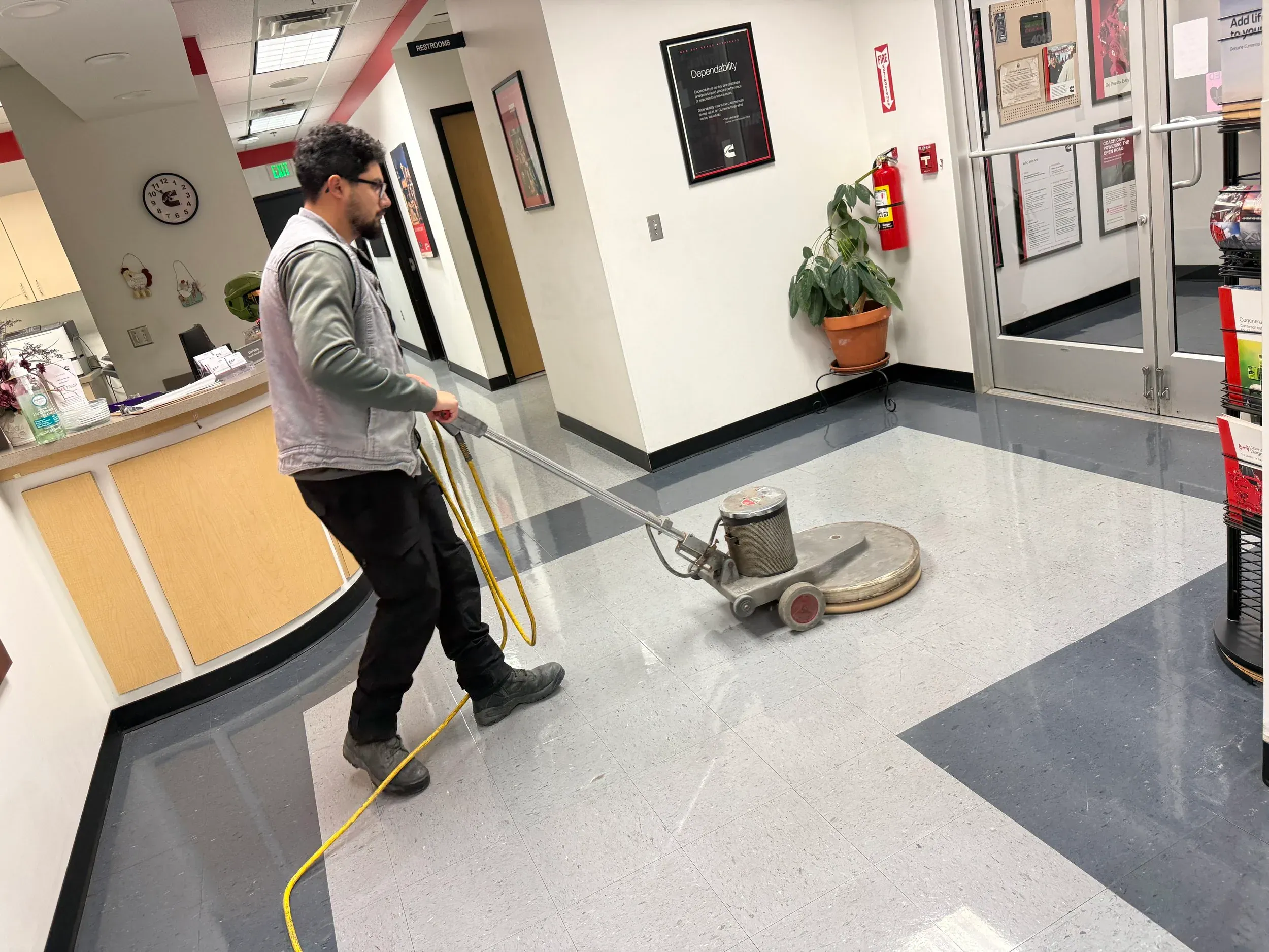 A commercial floor buffer polishing a finished floor to a gloss.