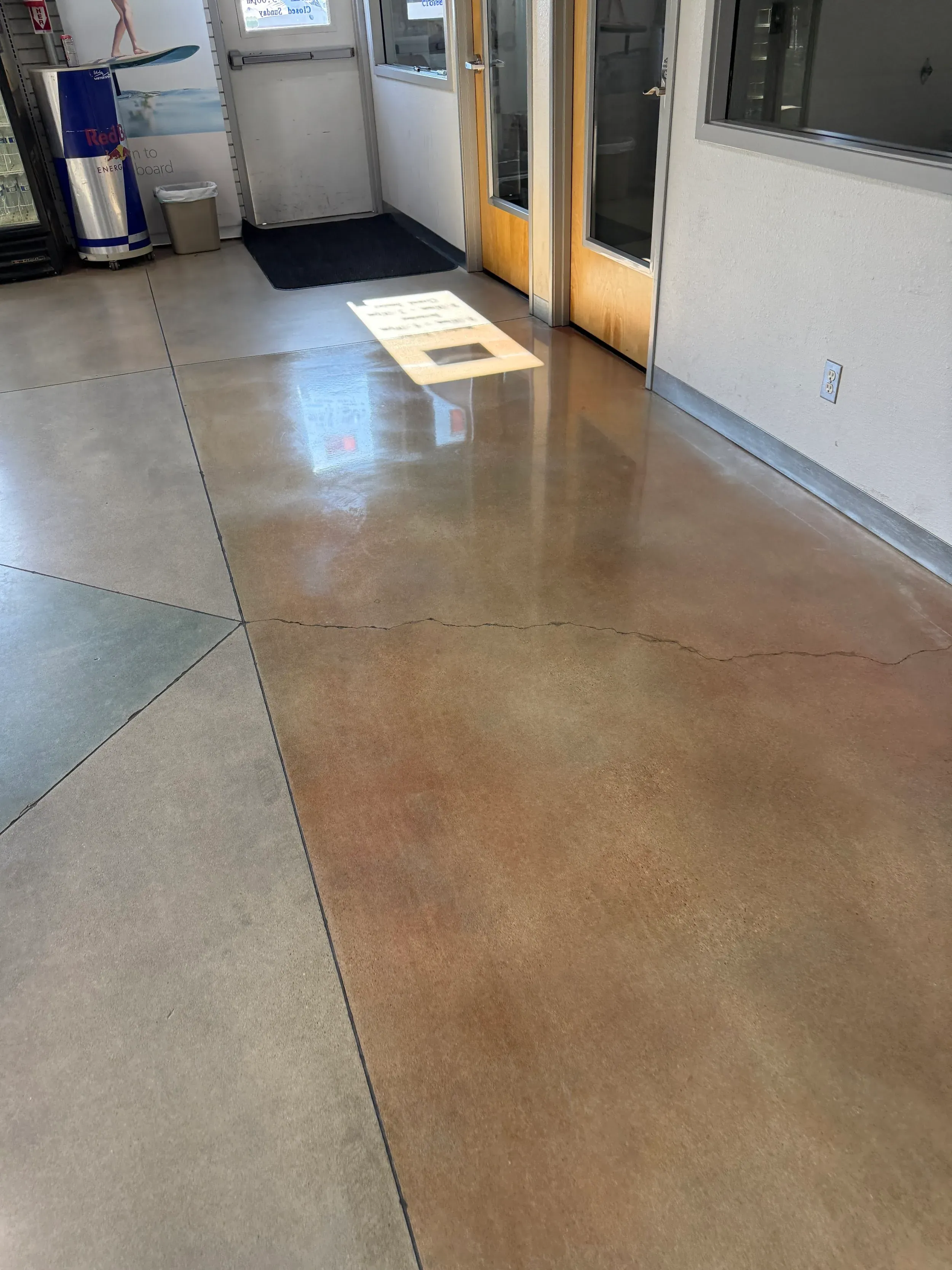 Sealed concrete flooring in a retail entryway, cleaned and protected against staining.